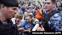 Russian police detain protesters during the march in central Moscow on June 12.