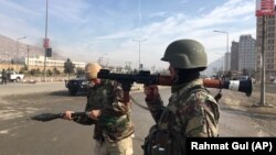 Afghan security personnel arrive at the site of a complex attack at an intelligence training center in Kabul on December 18.