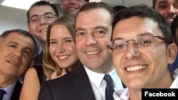 Ramil Ibragimov (right) takes a photo with Russian Prime Minister Dmitry Medvedev.