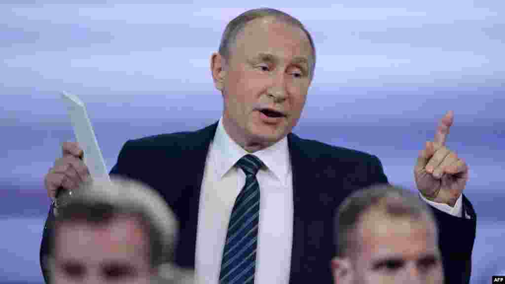 Russia -- Russian President Vladimir Putin gestures as he leaves a hall after his annual press conference in Moscow, December 17, 2015