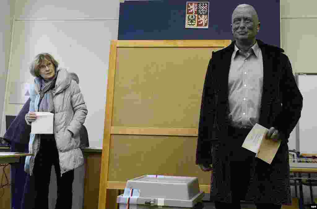 Presidential candidate Vladimir Franz, a musician and artist known for his full-body tattoos, waits to cast his ballot in Prague.