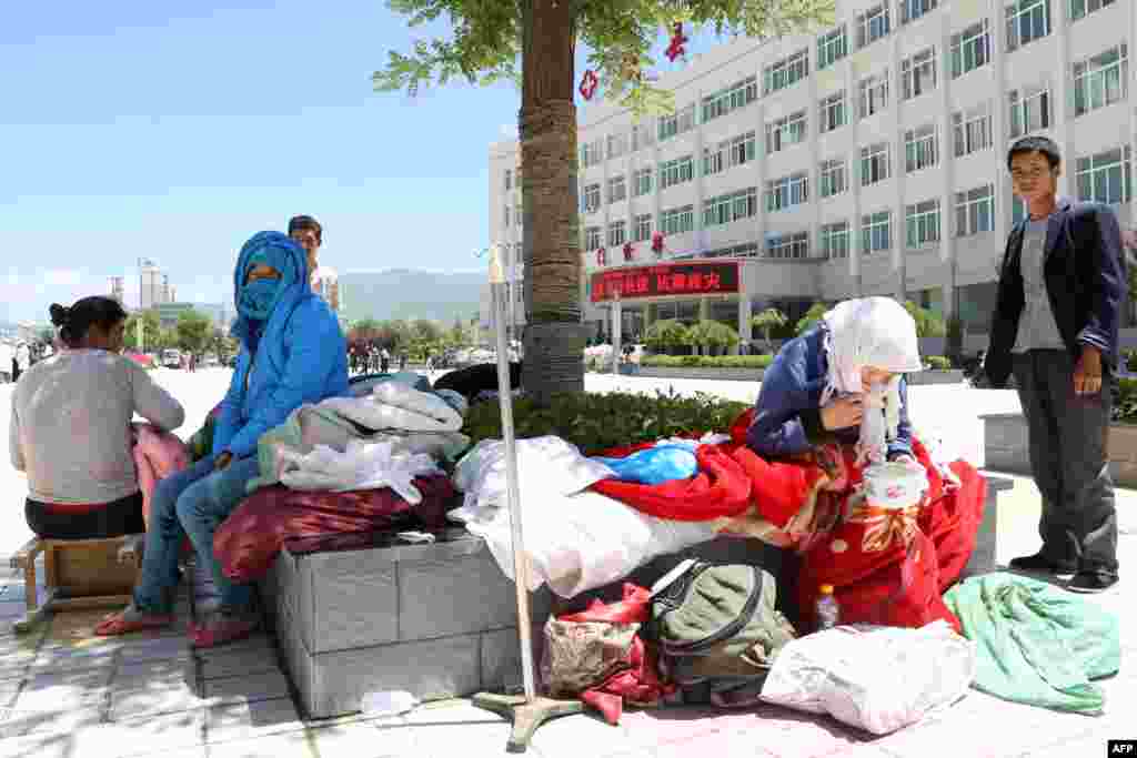 People wait to be admitted to a hospital.