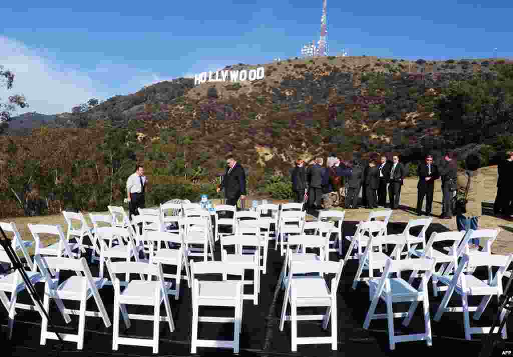 The freshly painted Hollywood sign is seen atop the Hollywood Hills following a press conference to announce the completion of the famous landmark's major makeover. Almost 1,400 liters of paint and primer were used to provide the iconic sign with its most extensive refurbishment in almost 35 years in advance of its 90th birthday next year. (AFP/Robyn Beck)