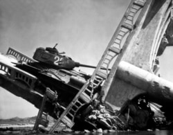 A North Korean tank that was caught in an airstrike as it was crossing a bridge near Suwon on October 7, 1950.