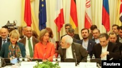 EU foreign policy chief Federica Mogherini (center left) and Iran's Foreign Minister Mohammad Javad Zarif (center right) hold talks in Vienna on July 6.