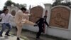 A supporter of former Pakistani President Pervez Musharraf kicks an anti-Musharraf lawyer outside a court in Rawalpindi on April 23.