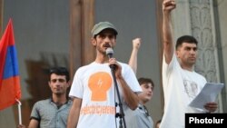"Electric Yerevan" protest leaders Narek Ayvazian (left) and Davit Sanasarian (right) hold a rally in Liberty Square in Yerevan on July 10. "We continue our fight. We will be successful," says Sanasarian.