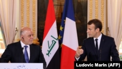 French President Emmanuel Macron (R) gives a press conference with Iraqi Prime minister Haidar al-Abadi following their meeting at the Elysee palace in Paris, October 5, 2017