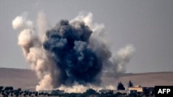 Smoke billows following air strikes by a Turkish Army jet fighter on the Syrian Turkish border village of Jarabulus during fighting against IS targets on August 24.