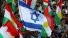 Iraqi Kurds fly an Israeli flag and Kurdish flags during an event to urge people to vote in the upcoming independence referendum in Arbil, the capital of the autonomous Kurdish region of northern Iraq.