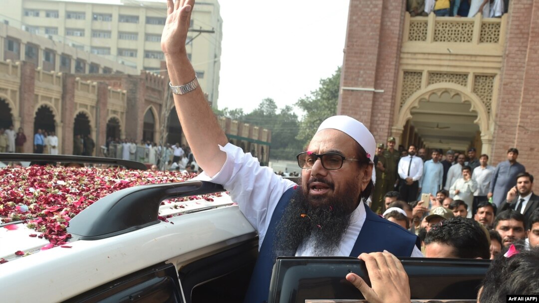 Hafiz Saeed, who has a $10 million U.S. bounty on his head, waves to supporters as he leaves a court in Lahore on October 19, 2017.