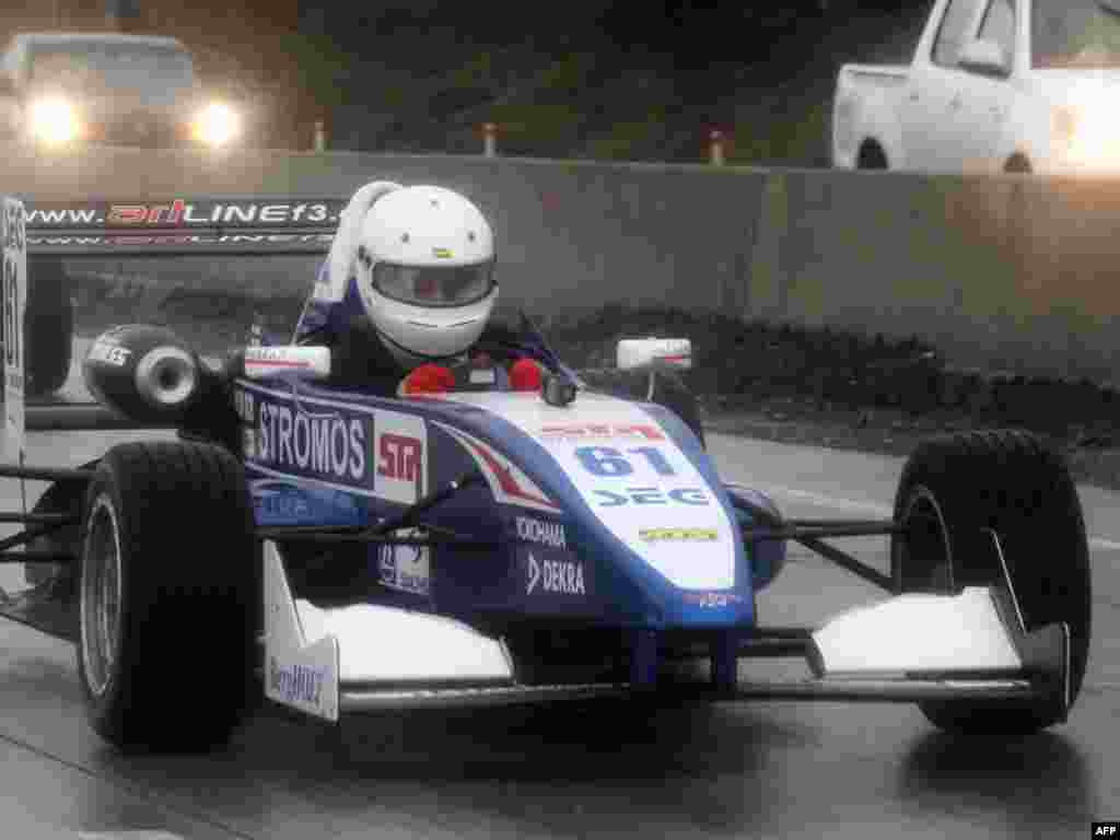 Georgian President Mikheil Saakashvili drives a Formula 3 racing car during the opening ceremony of a new highway. - Photo by Irakli Gedenidze for AFP
