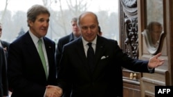 U.S. Secretary of State John Kerry (left) is welcomed by French Foreign Affairs Minister Laurent Fabius at the Quai d'Orsay Ministry in Paris on February 27.