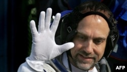 U.S. space tourist Richard Garriott waves as he boards the spacecraft at the Baikonur Cosmodrome in Kazakhstan.