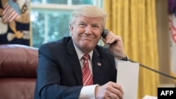 US President Donald Trump waits to speak on the phone with Irish Prime Minister Leo Varadkar to congratulate him on his recent election victory. June 27, 2017 File photo