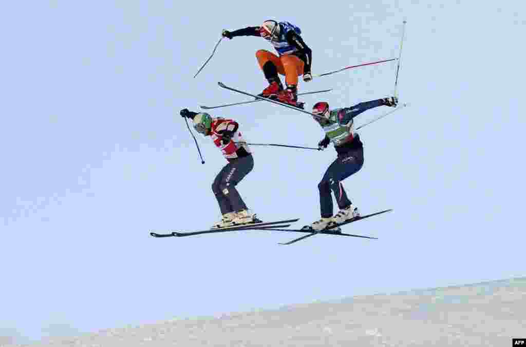 Brady Leman of Canada, Andreas Matt of Austria, and Daniel Bohnacker of Germany compete during the semifinal of the FIS men&#39;s Skicross World Cup at the Val Thorens ski resort in the French alps. (AFP/Philippe Desmazes)