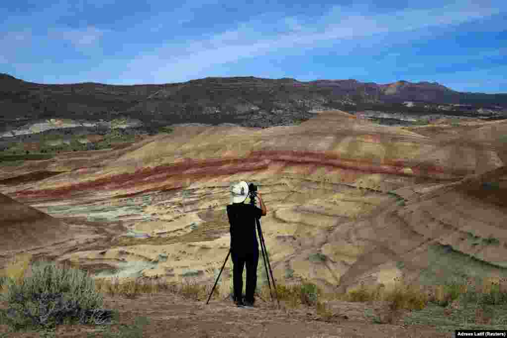 San Francisco Bay area resident Brian Martin photographs the Painted Hills, a unit of the John Day Fossil Beds National Monument, in preparation for the total lunar eclipse near Mitchell, Oregon, on August 20. (Reuters/Adrees Latif&nbsp;)