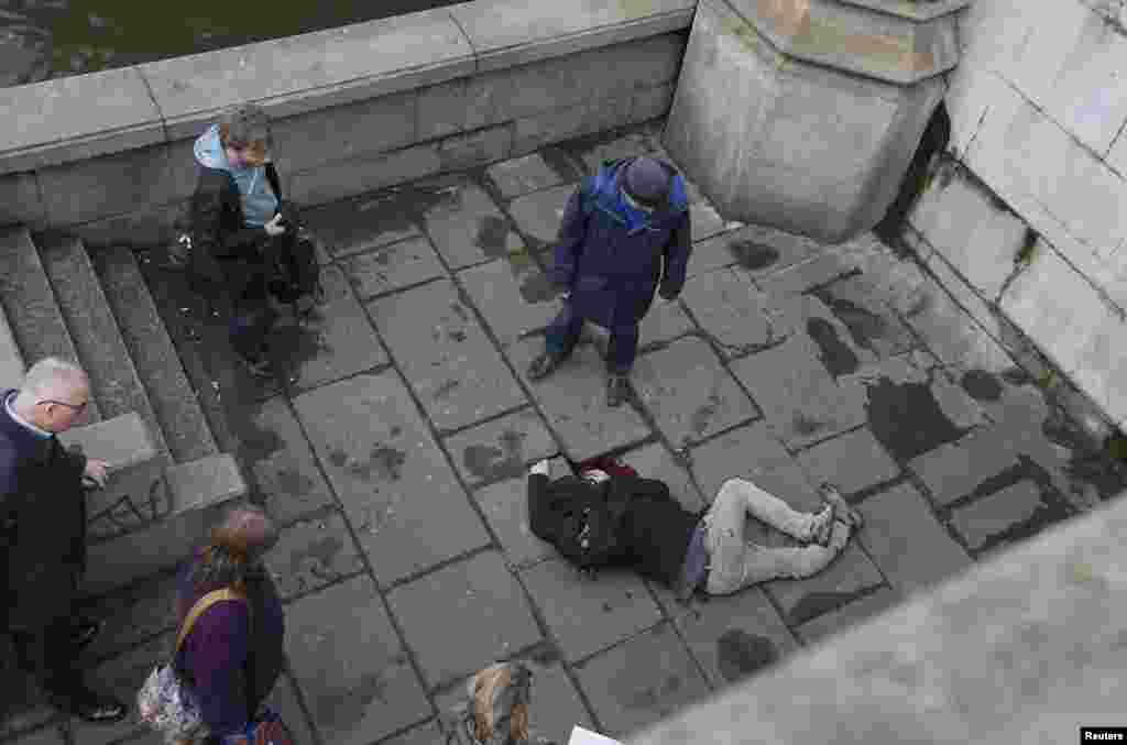 A gravely injured man lying next to the Thames after the incident