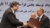 Patrick Pouyanne (left), chairman and CEO of the French energy company Total, shakes hands with Ezzatollah Akbari, managing director of the Petropars Group, after signing an offshore gas field agreement in Tehran on July 3.