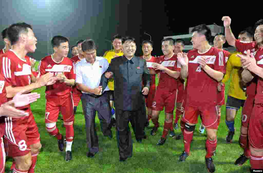 North Korean leader Kim Jong Un is applauded by players from the Hwaebul Team during their men's soccer match against the April 25 Team in Pyongyang. (Reuters/KCNA)
