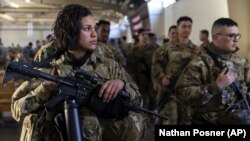 Members of the 82nd Airborne Division of the U.S. Army prepare for deployment to Poland from Fort Bragg, North Carolina, on February 14.