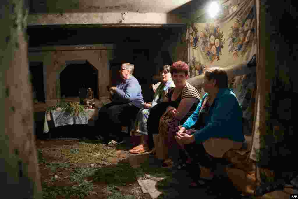 Residents of the large industrial town of Horlivka, in Ukraine's eastern Donetsk region, wait inside of their bomb shelter. (AFP/Andrey Borodulin)