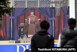 Японці з великих екранів на вулиці стежать за сходженням імператора на трон