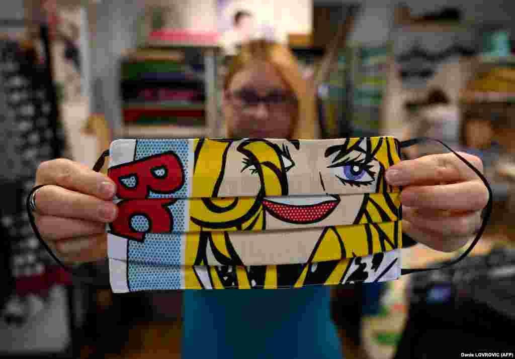 A woman presents a protective face mask designed by Croatian designer Zoran Aragovic. who designed a cotton mask in his distinctive pop-art style in Zagreb on March 3.