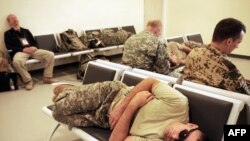 A U.S. soldier sleeps as he awaits a flight at the International Security Assistance Force (ISAF) airport in Kabul in September 2009.