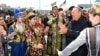 Нурсултан Назарбаев в бытность президентом Казахстана в окружении одетых в национальные костюмы людей на мероприятии в столице в День единства народа Казахстана. 1 мая 2018 года.
