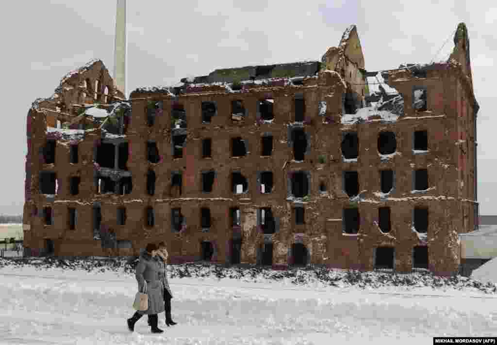 Women walk past a former mill that was a key stronghold in the Battle of Stalingrad, now named Volgograd. Russia on February 2 marked the 70th anniversary of the defeat of Nazi forces in one of the major turning points of World War II.