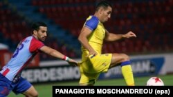 Panionios' Ehsan Hajsafi (L) vies for the ball with Tel Aviv's Eyal Golasa during the UEFA Europa League Third qualifying round soccer match. Athens, Greece, 03 August 2017.