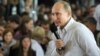 Vladimir Putin answers questions from the audience during his visit to the summer camp of the pro-Kremlin youth group Nashi at Lake Seliger on August 1.