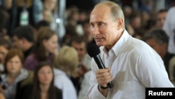 Vladimir Putin answers questions from the audience during his visit to the summer camp of the pro-Kremlin youth group Nashi at Lake Seliger on August 1.