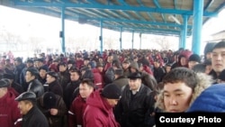 Workers on strike gather in Zhanaozen to demand higher wages.