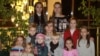 This photo from 2010 shows Katsyaryna Onakhava (top right) and her husband Alyaksandr (middle), along with two biological and seven adopted or foster children.
