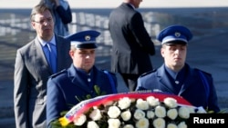 Serbian Prime Minister Aleksandar Vucic (left) laid a wreath of white roses at the memorial cemetery near Srebrenica on November 11.