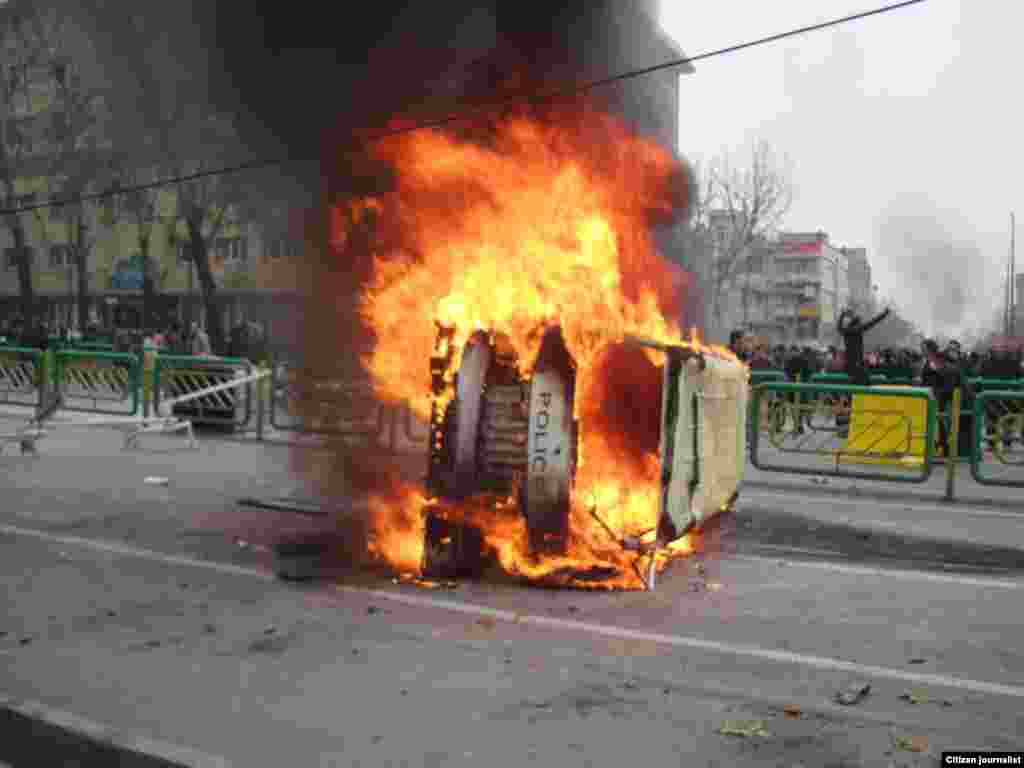 Iran -- Iranian protestors set fire on a police car during demonstrations against President Mahmud Ahmadinejad in Tehran, 27Dec2009