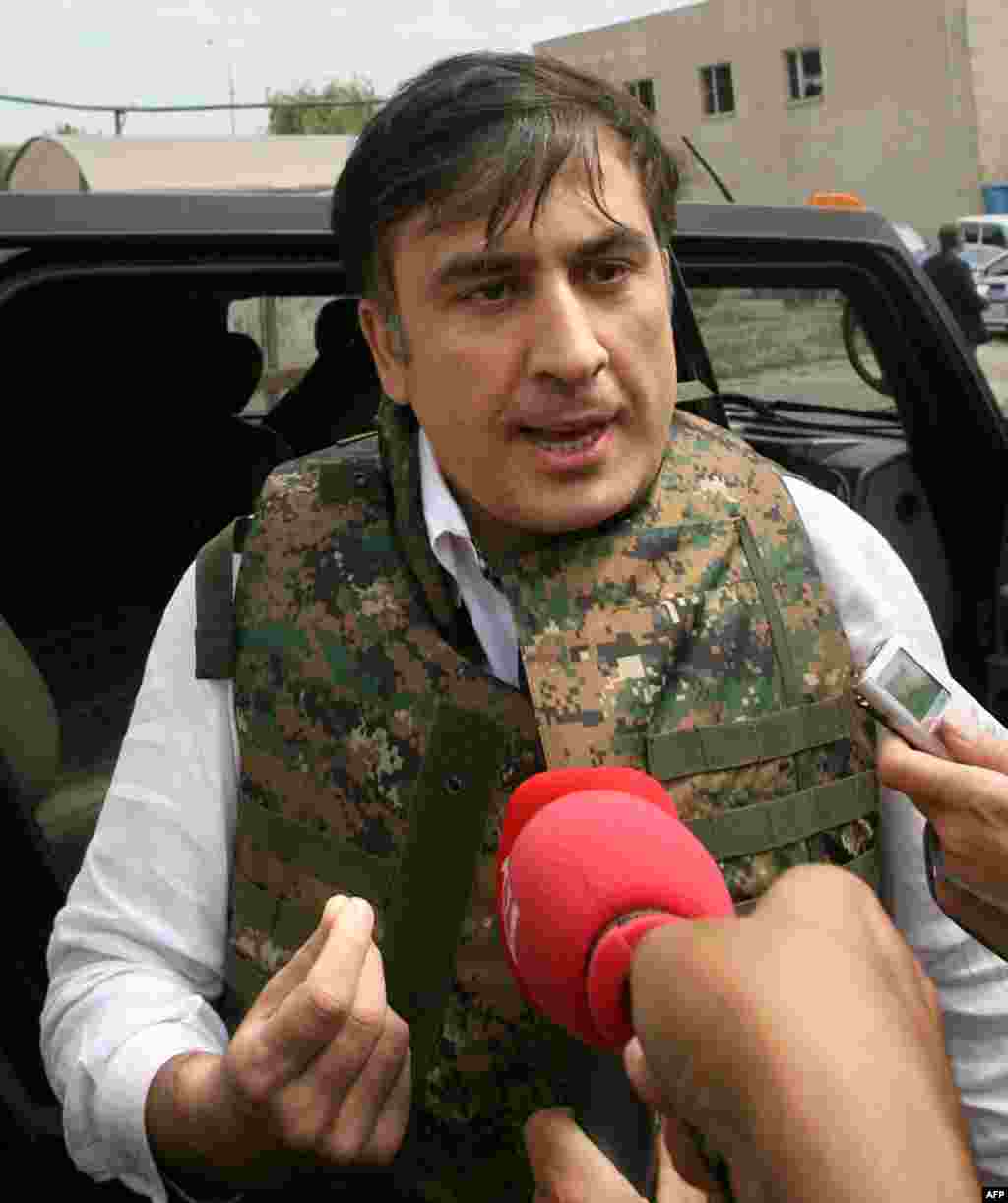 President Mikheil Saakashvili, in a camouflage bulletproof vest, visits the town of Gori on August 11, 2008, to examine damage resulting from the armed conflict between Russia and Georgia over the Georgian breakaway republics of Abkhazia and South Ossetia.