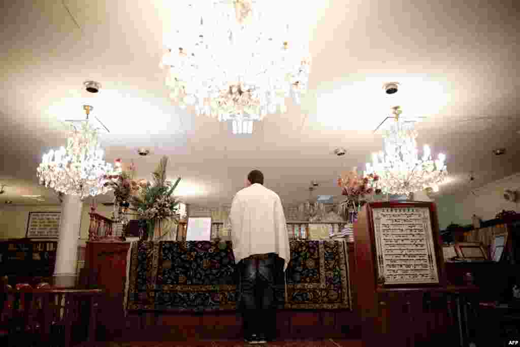 An Iranian Jew reads the Torah at a synagogue in downtown Tehran.