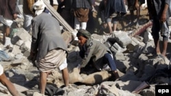 Yemenis search for survivors under the rubble of houses that allegedly were destroyed by a Saudi air strike, in Sana'a, Yemen on March 26.