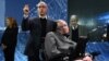 Yury Milner holds up a "Starchip" in the presence of renowned cosmologist Stephen Hawking in New York on April 12