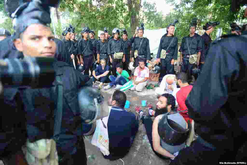 Security forces surround protesters detained at one of the protest camps. 