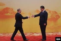 Russian President Vladimir Putin (left) Chinese President Xi Jinping in 2014. US legislation could target trade in Russian energy assets by countries such as China.