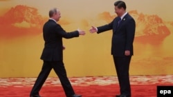Russian President Vladimir Putin (left) Chinese President Xi Jinping -- US legislation could target trade in Russian energy assets by countries such as China.