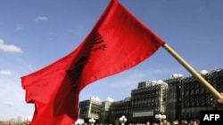 A Kosovar Albanian waves the Albanian flag during a protest against deployment of the EU mission in Pristina ealier this month.