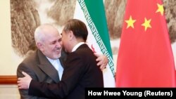 Chinese Foreign Minister Wang Yi meets with Iranian Foreign Minister Mohammad Javad Zarif at the Diaoyutai State Guesthouse in Beijing, August 26, 2019