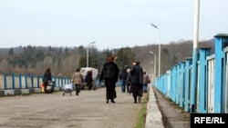 People cross the neutral zone of Enguri Bridge, between Abkhazia and the rest of Georgia.