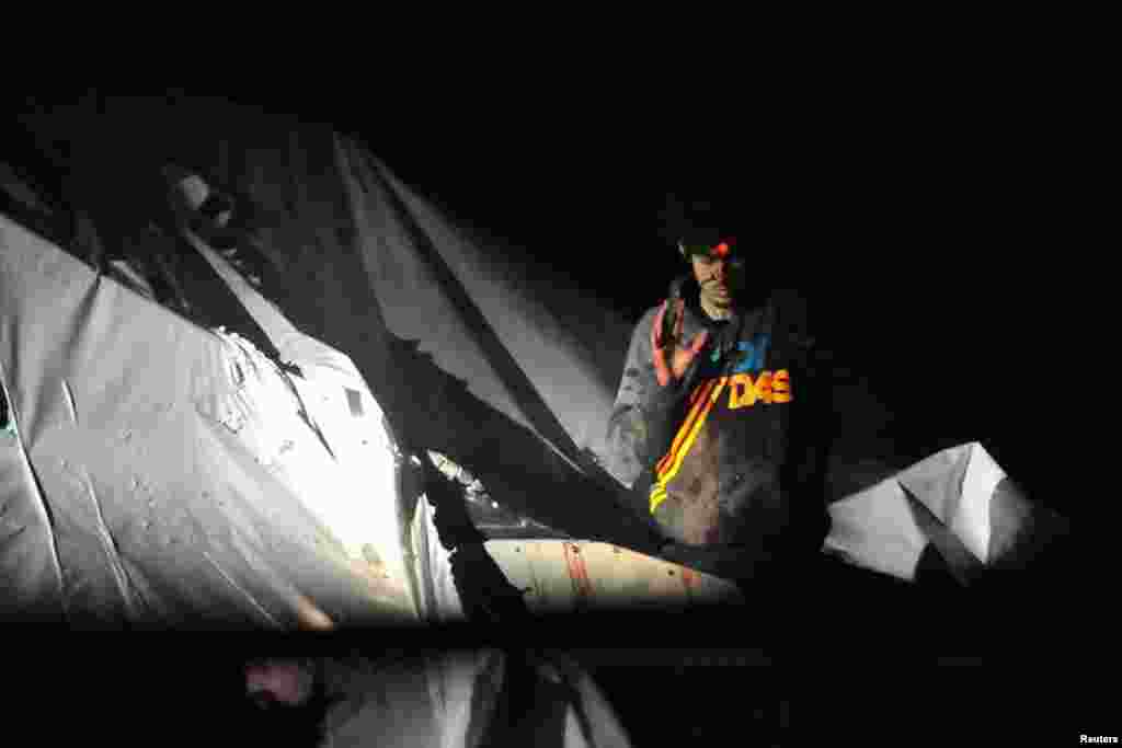 Accused Boston Marathon bomber Dzhokhar Tsarnaev is shown before his arrest with a sniper's laser sight trained on his head as he surrenders to authorities on April 19 after a massive manhunt. The photograph was provided courtesy of Massachusetts State Police Sergeant Sean Murphy and Boston Magazine. (Reuters)