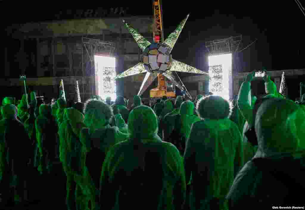 Visitors attend a presentation of the Artefact digital sculpture, which addresses problems of fake news, post-truth, and manipulation in media, at the central square of the abandoned city of Pripyat near the Chernobyl nuclear power plant on November 22. (Reuters/Gleb Garanich)
